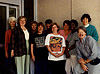 Nine women and one man stand for a photograph in front of a hospital entrance.