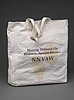 White cloth bag with handle, with text that identifies the organization.