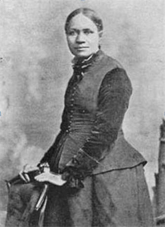 A young woman stand with her hands on a back of a chair.