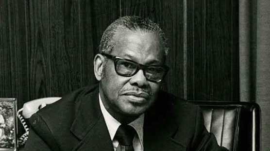 African American man (Leonidas Berry) seated and looking at viewer.