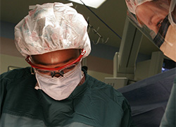 Two people working in a surgeon room.