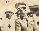 A White female nurse (Princess Maria Josè) arm in arm with a White male soldier.