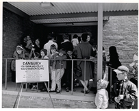 A photograph of people standing outside a building