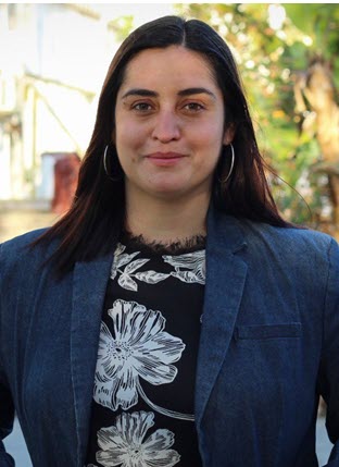 Informal photograph of a young woman outdoors.