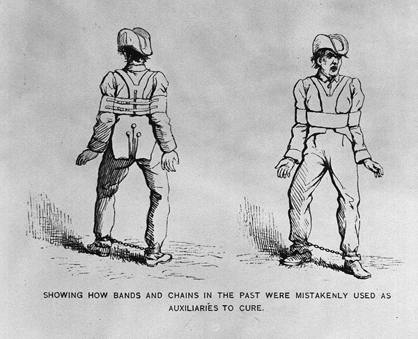 Front and back view of a man wearing a shoulder harness to immobilize his arms, and with his ankles shackled