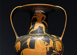 Vase painting featuring the bearded centaur; Achilles and Chiron are making eye contact; large, stylized flowers surround the pair.