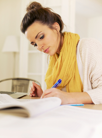 Woman studying with books and a computer